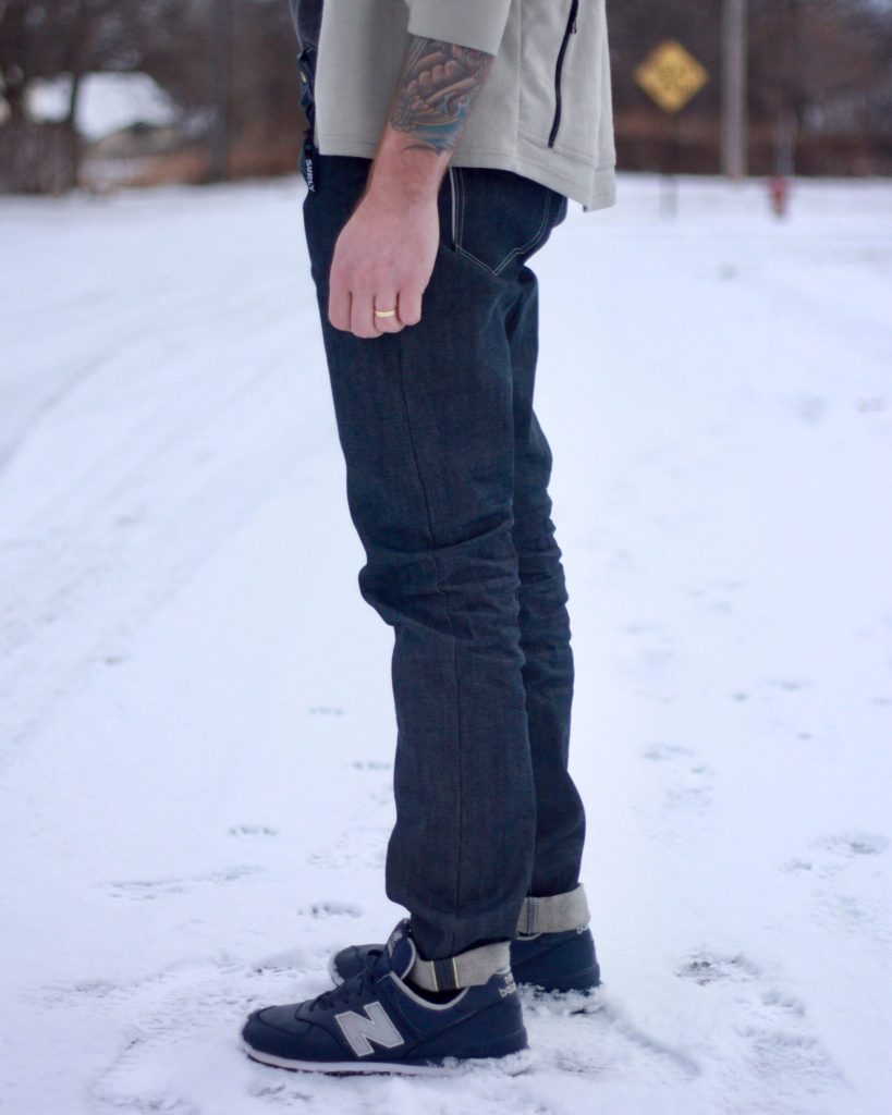 reflective jeans detail from the side view during the day