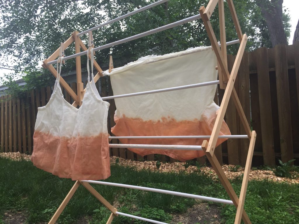 dip dyed tops drying on the rack